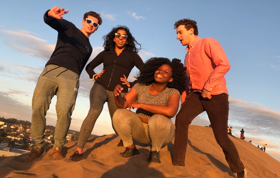 4 students on a sand hill in Chile